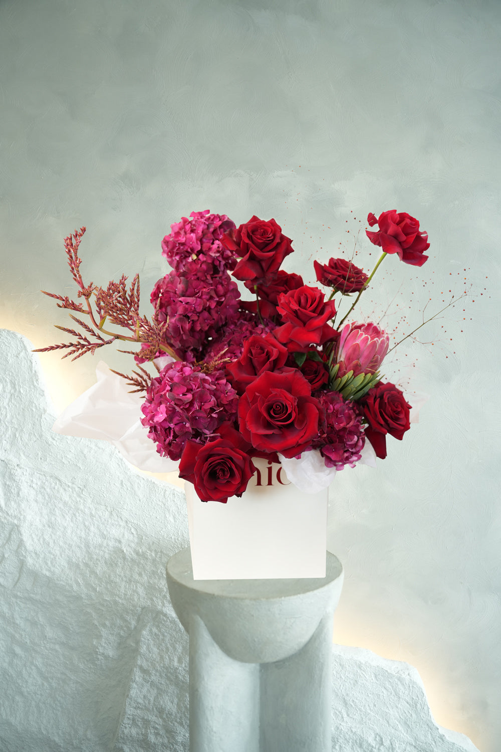 bouquet of red roses and red hydrangeas made by amicis flower shop