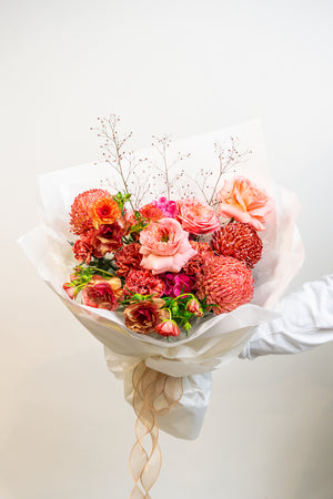 Bold, passionate, and timeless—Scarlet Whisper is a hand-tied bouquet in rich red hues, artfully composed to evoke deep emotion and refined drama. A floral statement of love, strength, and unforgettable elegance.