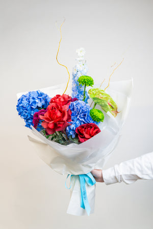 A vibrant celebration of color, Prism Bloom brings together the bold beauty of primary hues—radiant reds, sunshine yellows, and brilliant blues—in a joyful hand-tied bouquet. Bursting with energy and playful charm, it’s a spirited expression of creativity and confidence. by amicis uae