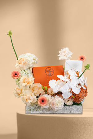 Floral arrangement with a gift curated by amicis florist