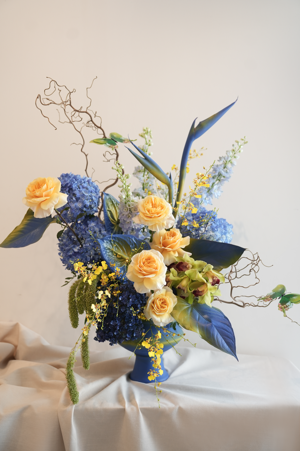 Floral arrangement with blue and yellow van gogh inspired flower vase arrangement by amicis flower boutique