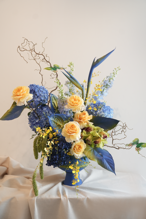 Floral arrangement with blue and yellow van gogh inspired flower vase arrangement by amicis flower boutique