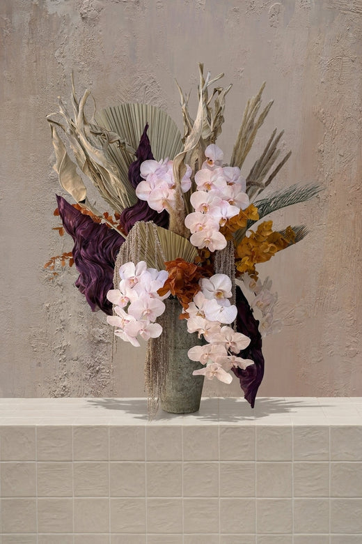 Amaranthine - blush orchids, deep purple leaves, ochre dried elements, pampas grass, and dried