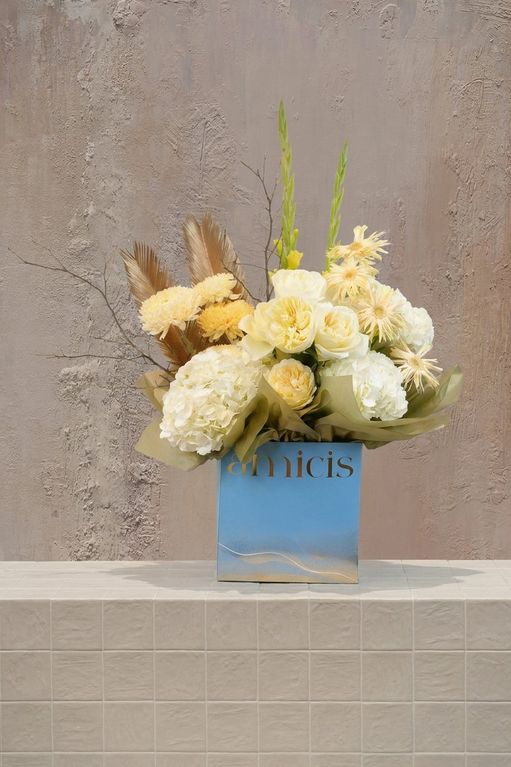 Amoré / 13 - cream garden roses, white hydrangeas, yellow chrysanthemums, and gold palm fronds in a light blue floral box by Amicis