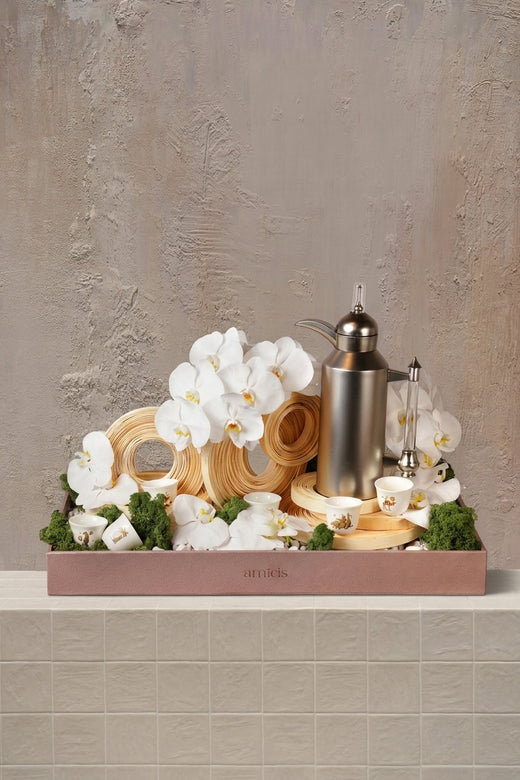Bamboo Spirals - white orchids, natural wood spirals, and green moss in a blush pink tray with a