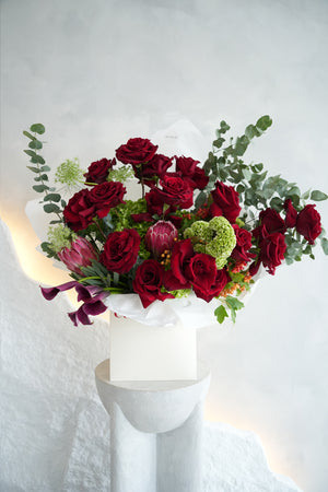 Bouquet of red roses and greenery in amicis white box to be deliver inside uae