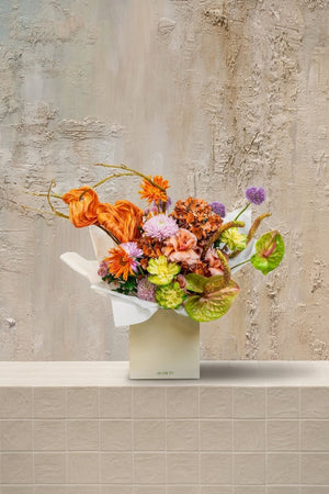 Bouquet No. 1925 - orange tulips, chrysanthemums, blush roses, green hydrangeas, purple alliums, and anthuriums in a cream gift box by Amicis