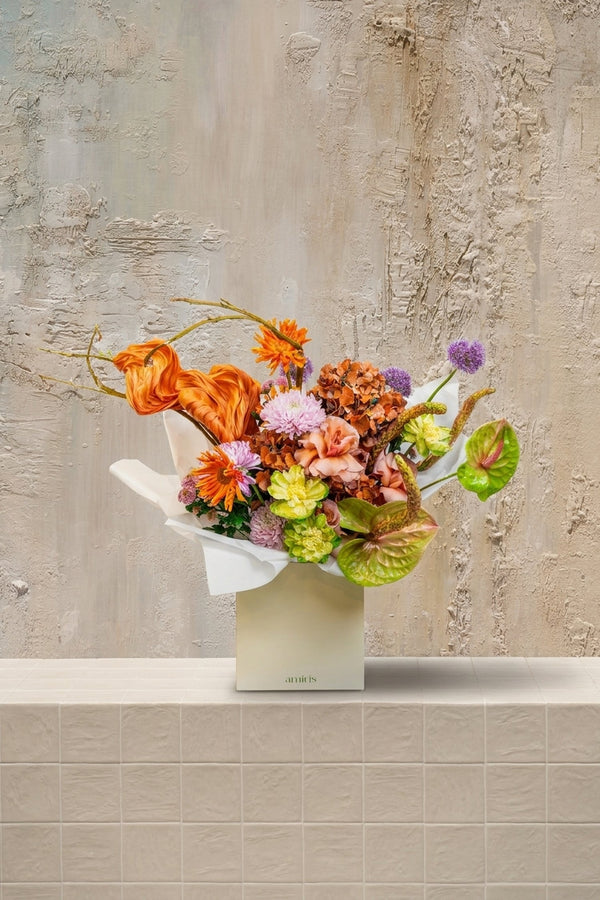 Bouquet No. 1925 - orange tulips, chrysanthemums, blush roses, green hydrangeas, purple alliums, and anthuriums in a cream gift box by Amicis