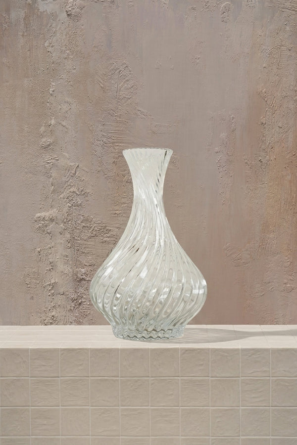 Crystal Oracle - white roses, cream hydrangeas, and delicate orchids in a clear twisted glass vase by Amicis.