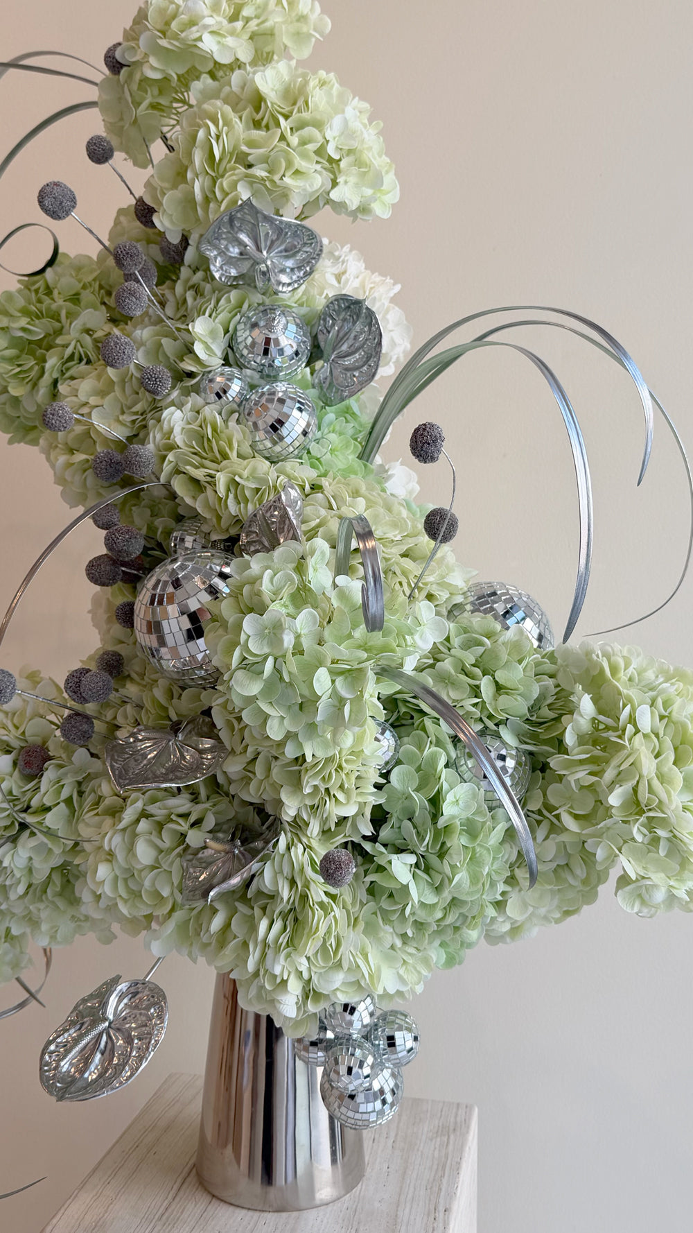 Hydrengea Sparks - lime green hydrangeas with silver disco balls and decorative accents in a silver ribbed vase by Amicis