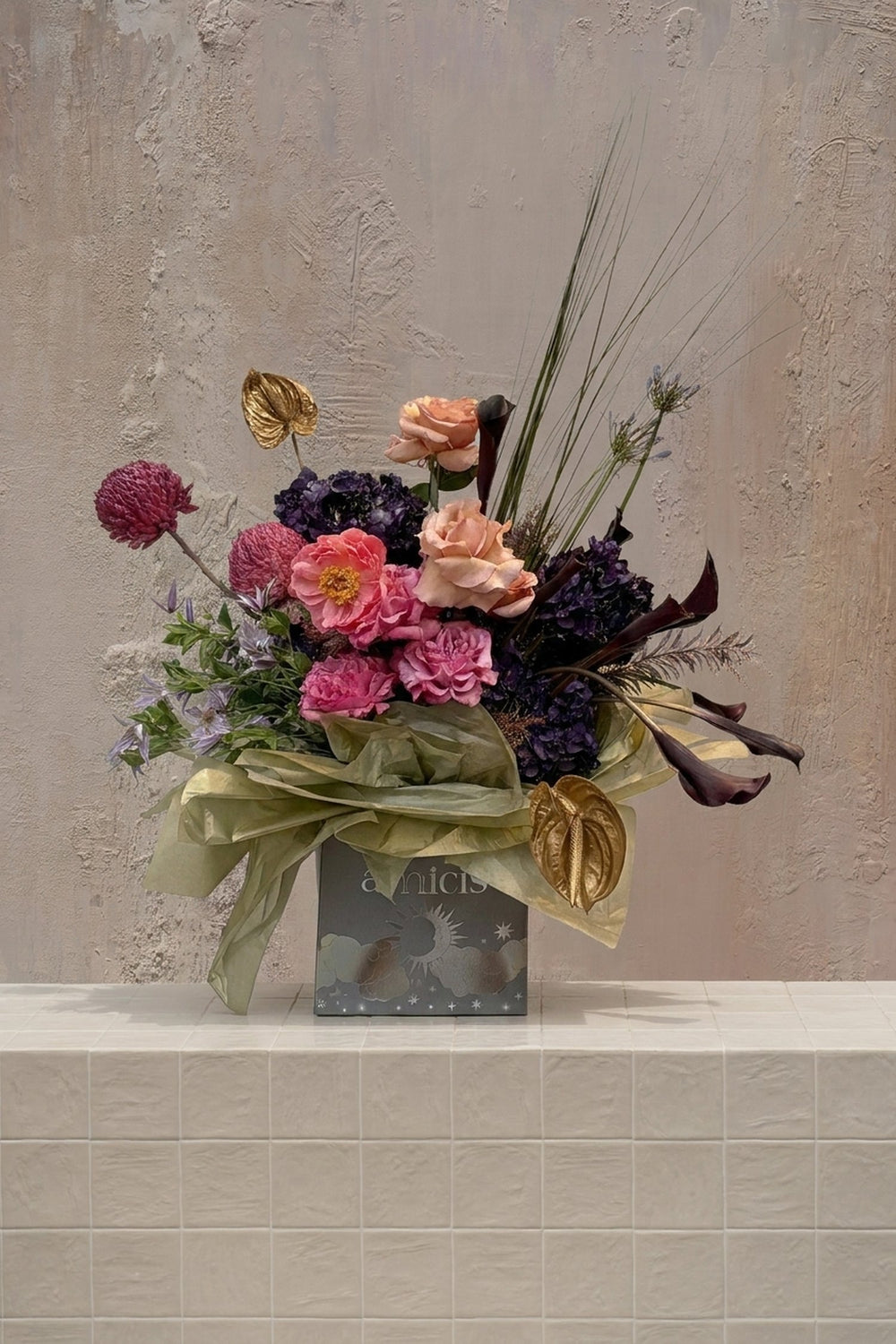 Eclipse 11 - pink & peach roses, deep purple hydrangeas, golden anthurium, and dark calla lilies in a decorative gift box by Amicis
