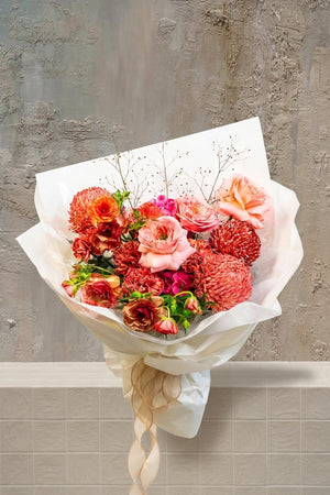Bold, passionate, and timeless—Scarlet Whisper is a hand-tied bouquet in rich red hues, artfully composed to evoke deep emotion and refined drama. A floral statement of love, strength, and unforgettable elegance.