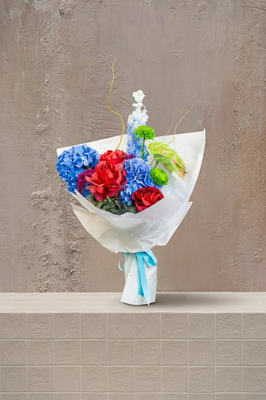 Prism Bloom - deep blue hydrangeas, red roses, green chrysanthemums, anthurium, and white