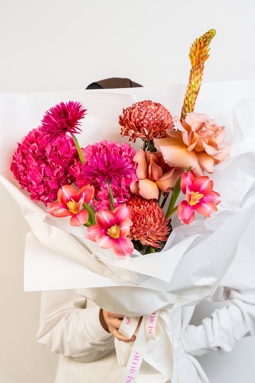  A lush blend of peach, pink, and fuchsia blooms, Rosé Rhapsody is a hand-tied bouquet that dances with feminine energy and modern romance. Bursting with color and charm, it's a captivating arrangement made to celebrate beauty in all its bold and delicate forms. flower by amicis flower boutique in uae