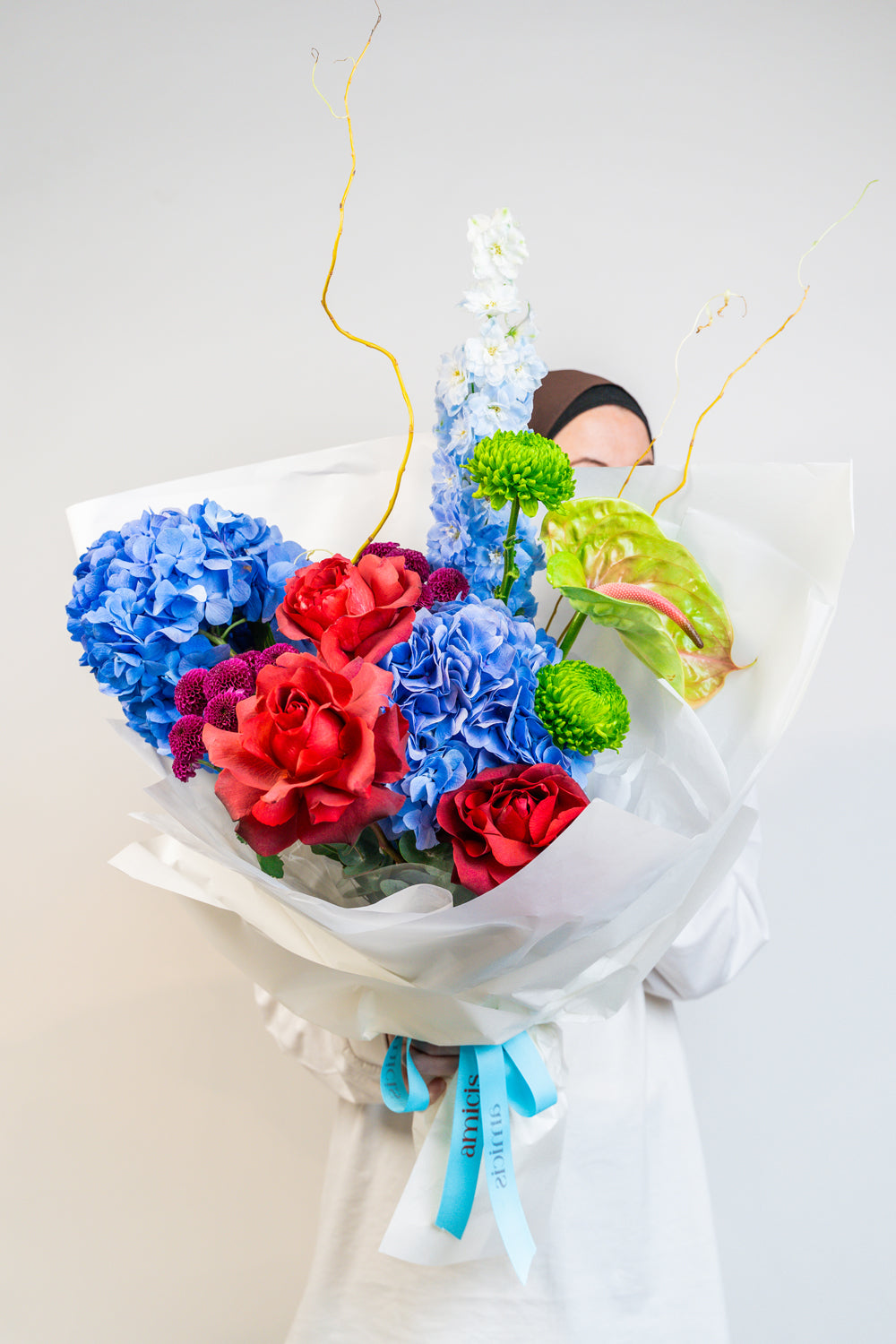 A vibrant celebration of color, Prism Bloom brings together the bold beauty of primary hues—radiant reds, sunshine yellows, and brilliant blues—in a joyful hand-tied bouquet. Bursting with energy and playful charm, it’s a spirited expression of creativity and confidence. by amicis uae