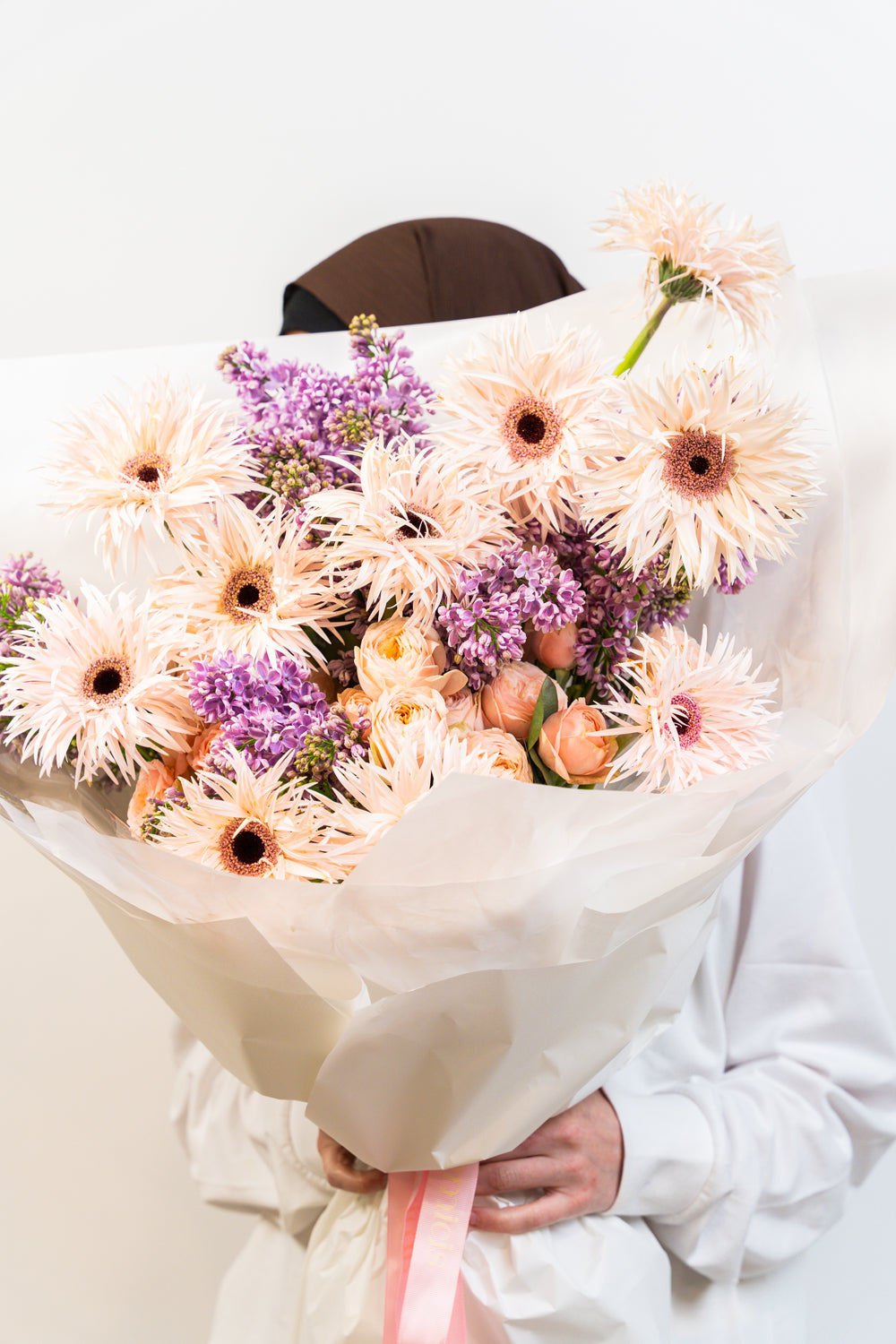 Soft peach tones meet rich purples in Velvet Dusk—a hand-tied bouquet that captures the quiet beauty of twilight. Elegant, romantic, and thoughtfully composed, it's a floral poem for moments that deserve to be remembered.
