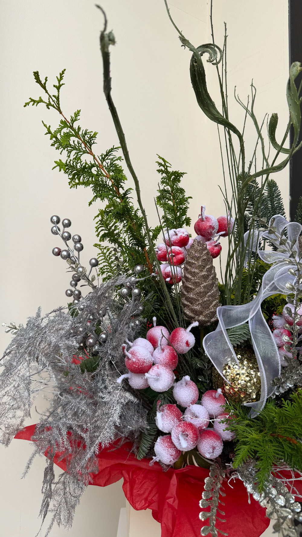 Sparkle Holidays 04 - festive green pine, frosted red berries, gold baubles, and silver foliage in a cream gift bag by Amicis