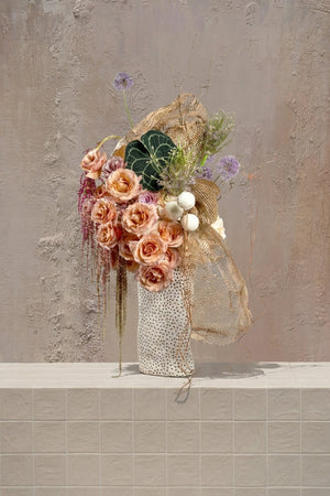 Honey Bee - peach roses, lavender alliums, amaranthus, anthurium leaf, and gold mesh in a polka-dot vase by Amicis