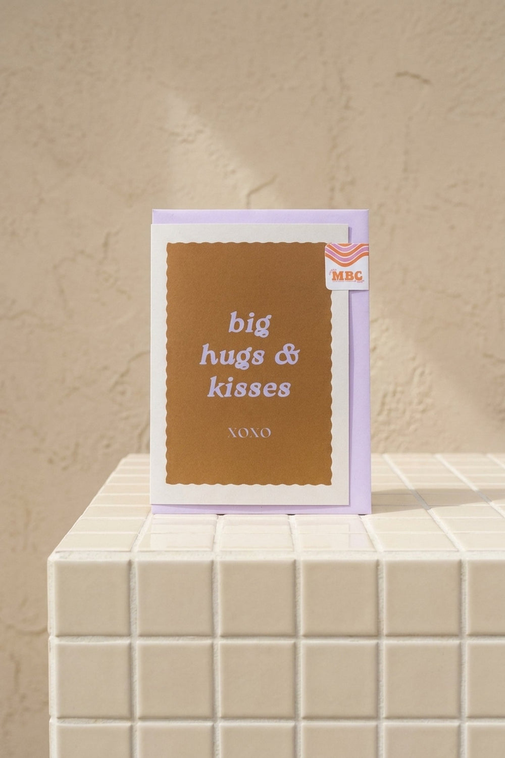 Hugs & Kisses - lavender greeting card with a metallic bronze "big hugs & kisses" panel and XOXO text by Amicis