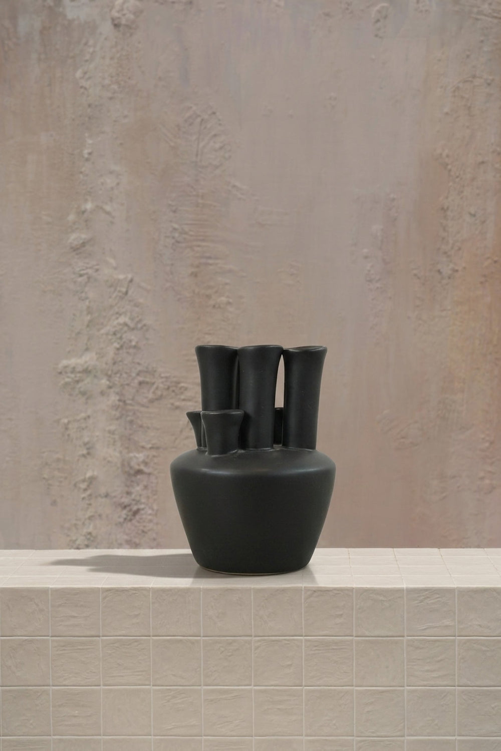 Pipe for pipe - blush pink roses and white orchids in a striking black ceramic multi-opening vase by Amicis