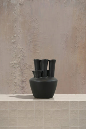 Pipe for pipe - blush pink roses and white orchids in a striking black ceramic multi-opening vase by Amicis