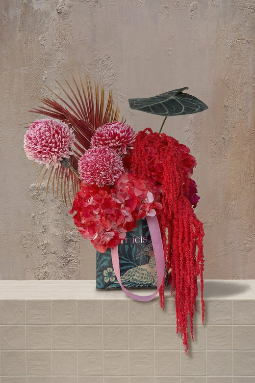 Pocket Posy - pink chrysanthemums, red hydrangeas, red amaranthus, and dried palm with anthurium