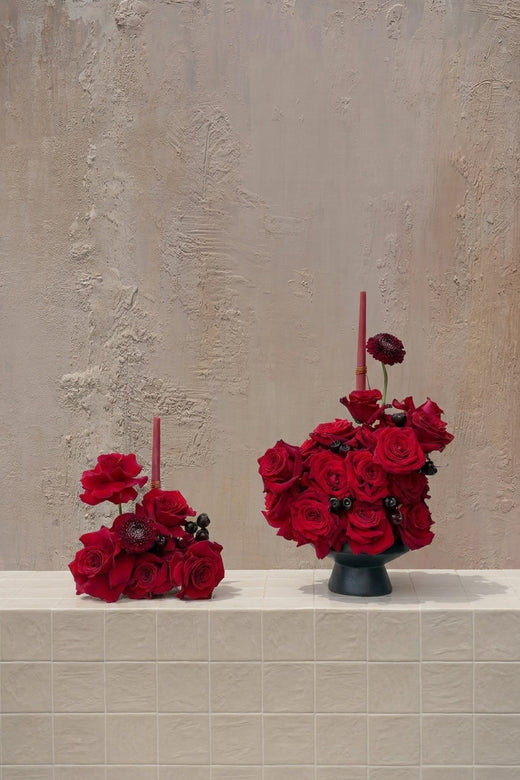 Roses Top - deep red roses, dark red scabiosa, and black berries in a dark grey ceramic vase by