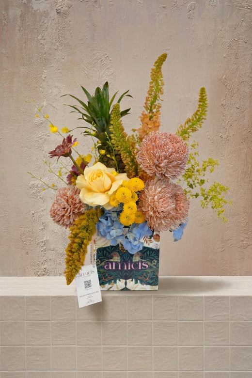 Sage - yellow rose, peach chrysanthemums, blue hydrangeas, green celosia, and pineapple in a