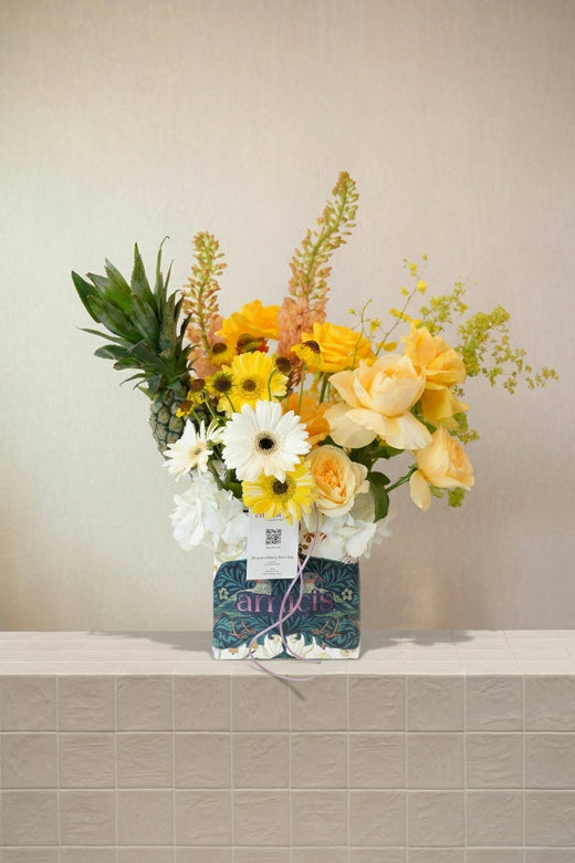 Sona - pale yellow roses, white & yellow gerberas, peach celosia, white hydrangeas, and a pineapple