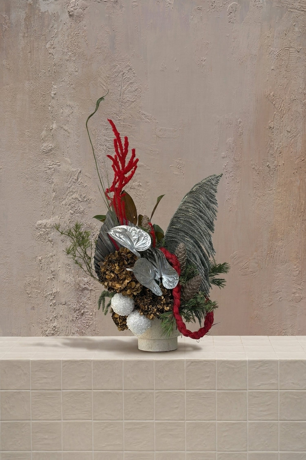 Sparkle Holidays 14 - vibrant red amaranthus, silver anthurium, brown dried hydrangeas, and green pine in a cream ceramic pot by Amicis