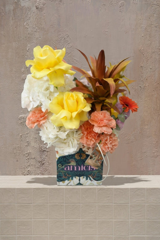 Untamed - yellow roses, white & peach carnations, orange gerbera, and bronze foliage in a patterned