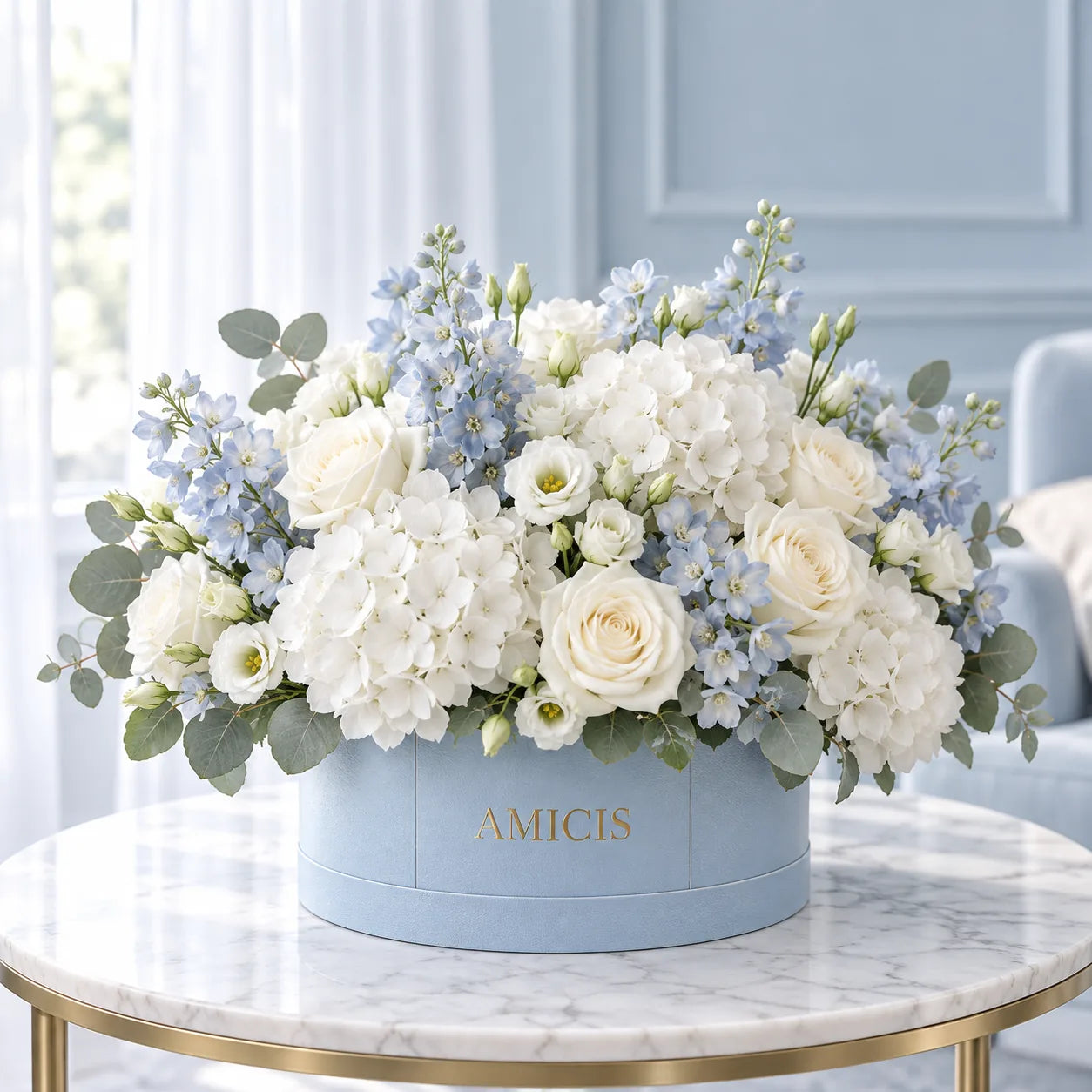 White hydrangeas and roses in a blue Amicis box, delivered to Al Ain